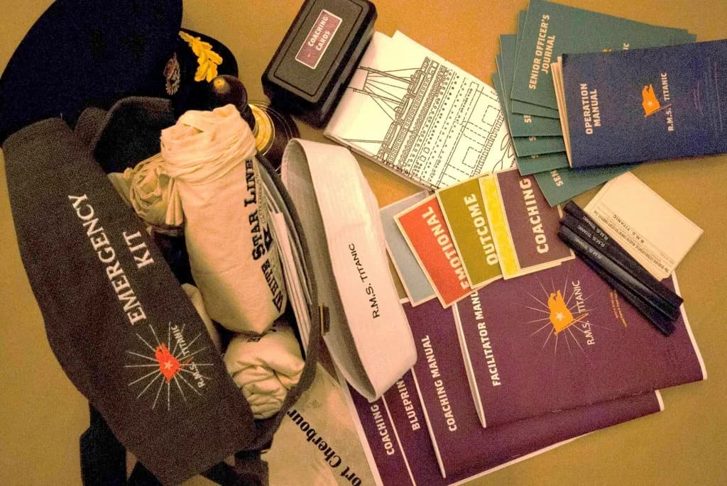 Complete Save the Titanic materials kit — captain hat, emergency kit, Senior Officer Journal, Operation Manual, coaching cards, facilitator manual, and ship blueprints