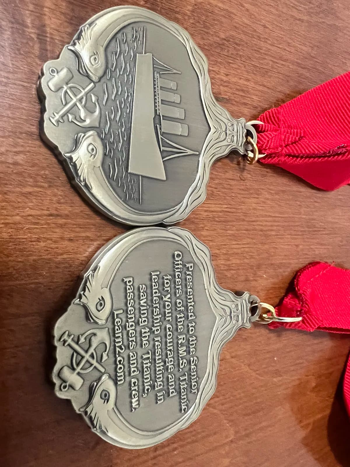 Save the Titanic commemorative medal showing detailed ship engraving — a keepsake each participant receives